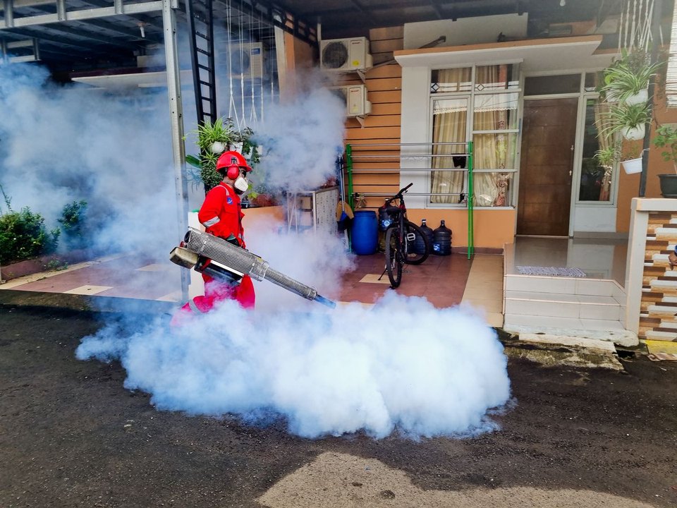 Technician fogging a building exterior - Pest Disinfection Sydney