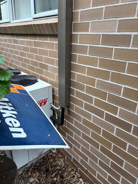 Air-conditioning services running up the exterior wall towards the roof
