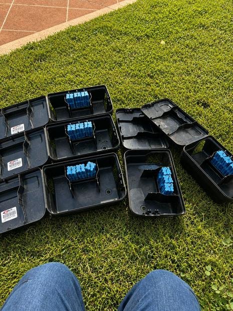Rodenticide blocks secured inside locked stations